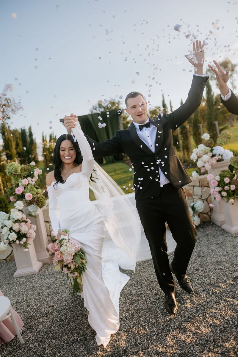 A confetti exit, the couple cheering
