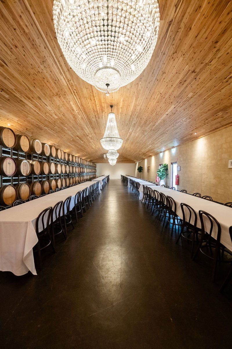 Gigi&rsquo;s set with long tables, the barrel wall and chandeliers